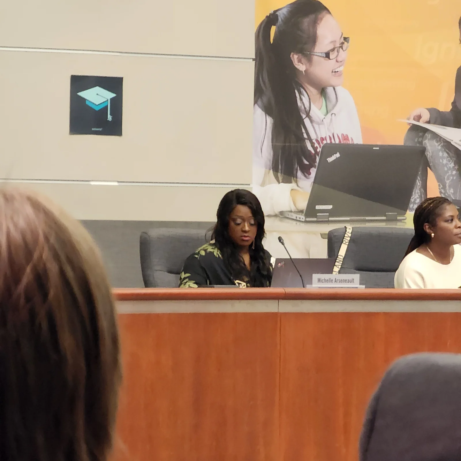 Michelle at a school board meeting